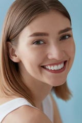 Smiling woman with beauty face and white teeth smile closeup