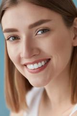 Smiling woman with beauty face and white teeth smile closeup