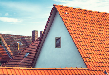 Modern European rooftops with tiles and chimneys