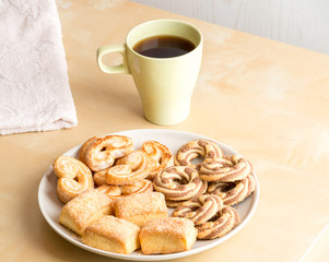 Shortbread cookies and cup with coffee on wooden table