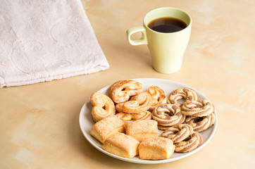 Shortbread cookies and cup with coffee on wooden table