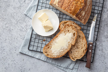 slices of freshly baked homemade sour dough bread with butter