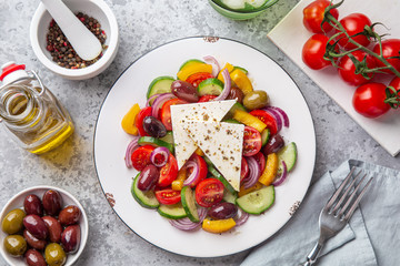 greek salad ( tomato, cucumber, bel pepper, olives  and feta cheese) in white plate