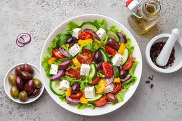 greek salad ( tomato, cucumber, bel pepper, olives  and feta cheese) in white bowl