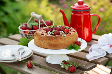 cake with fresh strawberry on wooden table, outdoor