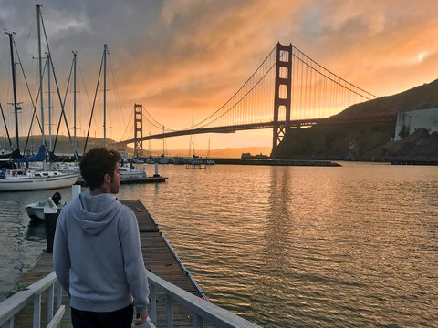 man from behind looking to golden gate bridge