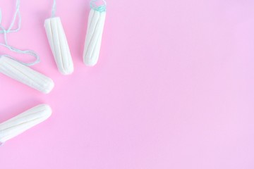 Fototapeta na wymiar Cotton Hygienic tampons for women period days with selective focus on blurred pink background with empty space for text. Personal protection tampon for menstruated period. Females healthcare 