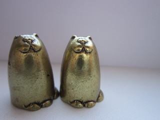 Cats of metal brass on a white background.