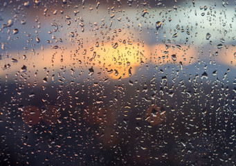 Fototapeta na wymiar Rain drops on the glass