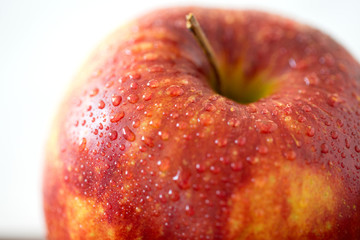 fruits, food and harvest concept - close up of ripe red apple