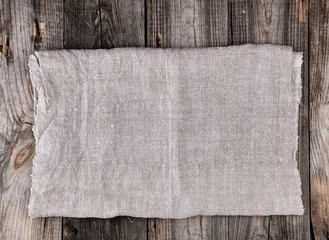 folded gray towel on wooden background