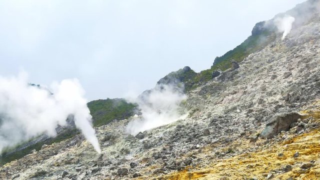 Sibayak volcano, active caldera steaming, travel destination in Berastagi, Sumatra, Indonesia. Close up of fumaroles and sulphur geysers.