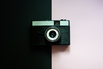 Film retro camera on a black and pink background 5
