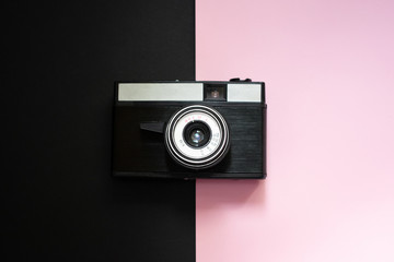 Film retro camera on a black and pink background 6