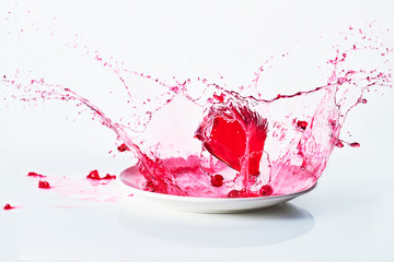 red cube of jelly falling and bouncing in red liquid