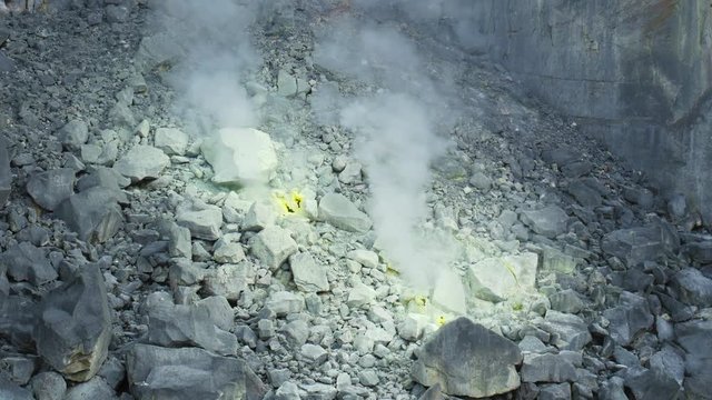 Sibayak volcano, active caldera steaming, travel destination in Berastagi, Sumatra, Indonesia. Close up of fumaroles and sulphur geysers.