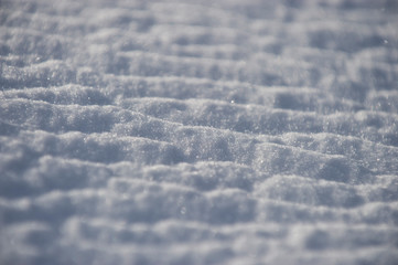 A pattern of wind-blown snow on a bright sunny and cold winter day.