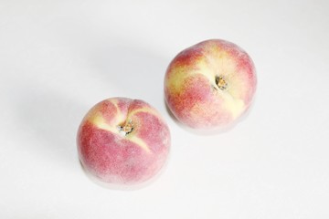 Peaches lying on the table on a white background