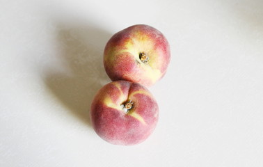Peaches lying on the table on a white background