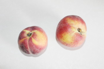 Peaches lying on the table on a white background