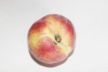 Peaches lying on the table on a white background