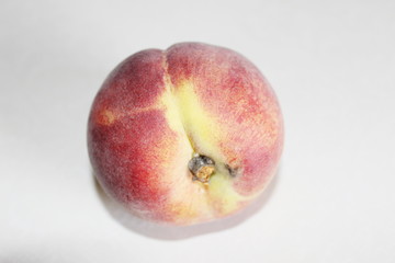 Peaches lying on the table on a white background