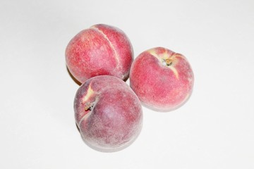 Peaches lying on the table on a white background
