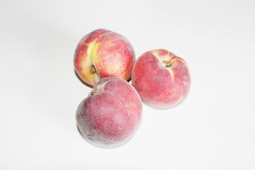 Peaches lying on the table on a white background
