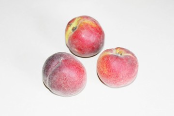 Peaches lying on the table on a white background