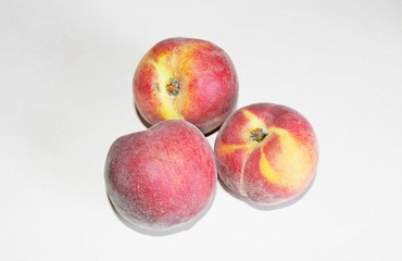 Peaches lying on the table on a white background