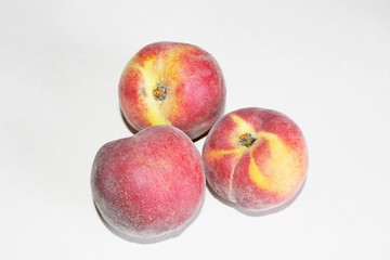 Peaches lying on the table on a white background