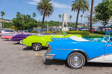 Cuba, Havana. Old classic American cars, used as Taxi, parked next to popular tourist atractions at old part of the city.
