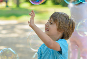 Cute Baby Catching Soap Bubbles