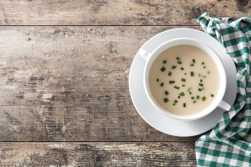 French vichyssoise soup in bowl on wooden table. Top view.Copyspace