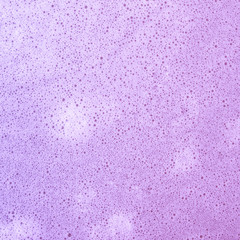 Full frame of pink bath bomb surface with bubbles