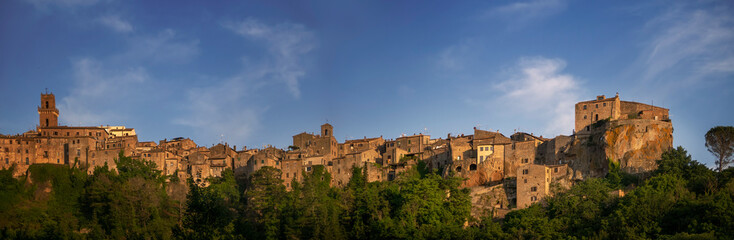 Fototapeta na wymiar PITIGLIANO, TUSCANY, ITALY - JUNE 2019 - View of Pitigliano town, golden hour. Picturesque and unusual - built on tuff, tufo, tufaceous volcanic rock.