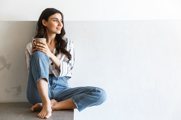 Beautiful young girl sitting at the kitchen counter