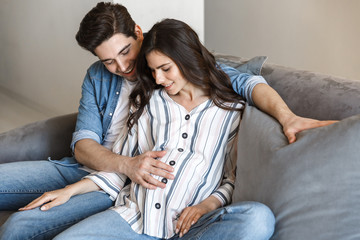 Attractive young pregnant couple relaxing