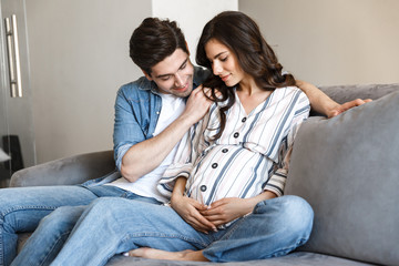Attractive young pregnant couple relaxing
