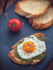 Poached egg and pesto sauce on toast for the breakfast