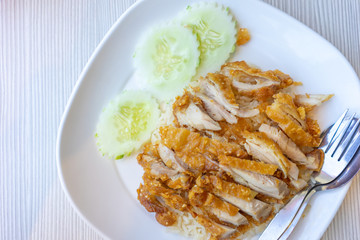 Fried chicken rice, placed on a white plate, should be considered a food and health concept. with copy space.