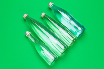 Water bottle flat lay top view on color paper background