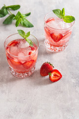 Strawberry lemonade on a grey background. Copy space. Refreshing summer drinks.