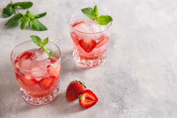 Strawberry lemonade on a grey background. Copy space. Refreshing summer drinks.