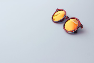 Red sunglasses on white background.