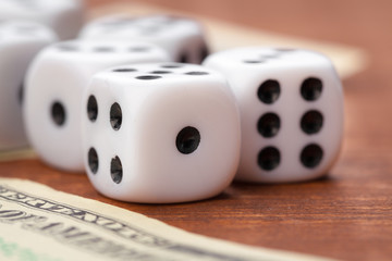 Playing Dices and Stack of American Dollars Bills.
