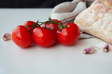 Fresh tomatoes on wooden desk with garlic