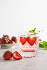 Strawberry lemonade on a grey background. Copy space. Refreshing summer drink.