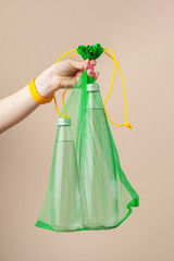 Mesh bags with reusable glass water bottle. Sustainable lifestyle. Zero waste concept. No plastic.