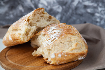 Loaf of fresh bread on wooden board
